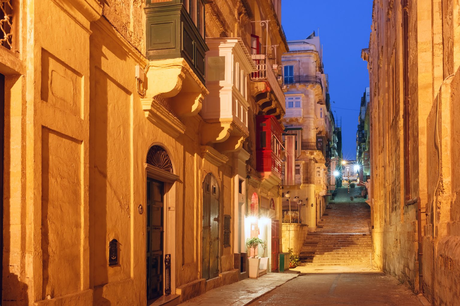 Typical Maltese medieval street at night in the center of the Old Town of Valletta, Malta